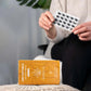 In the foreground, the package of CBD capsules; in the background, the customer holds the capsules.